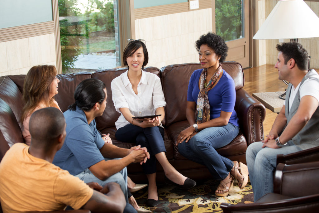 A group discussing their careers. Managing a strategic career transition takes leveraging a network, Job hunting in the right circles, and being proactive about what's next.
